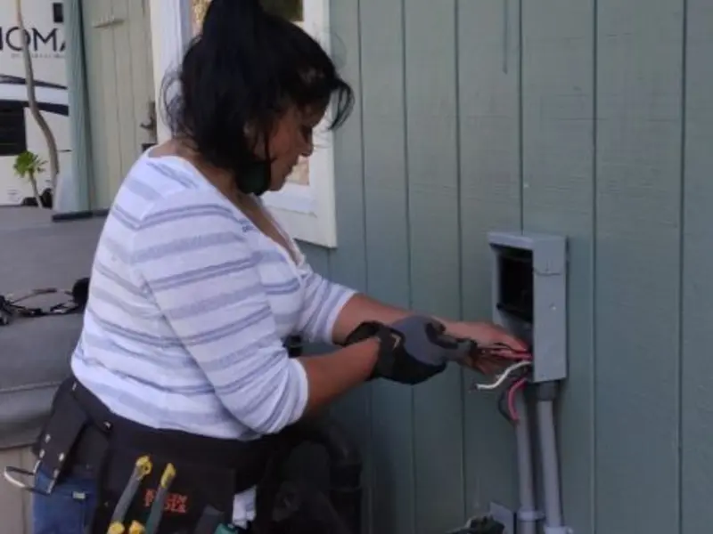 Licensed electrician wiring an exterior subpanel in Benner