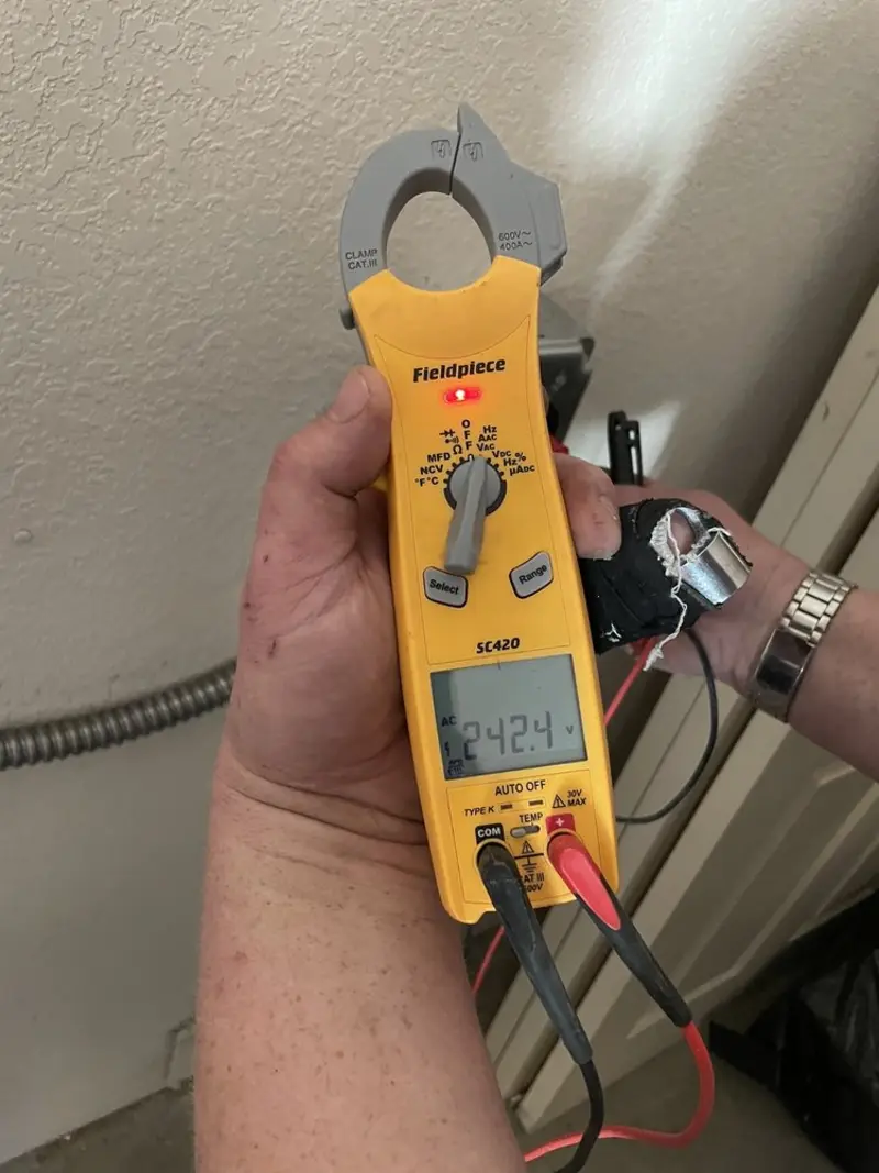 Voltage testing with clamp meter during Whole House Surge Protector in Benner